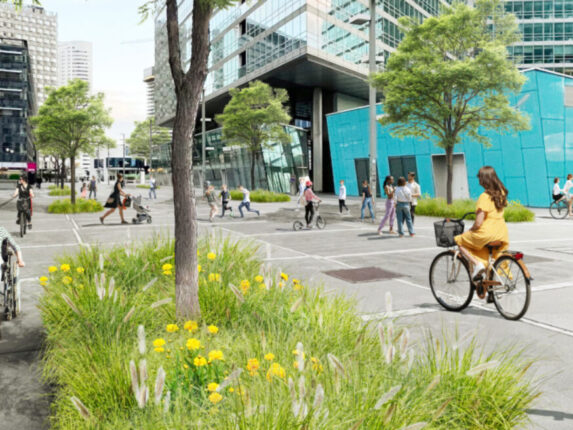 Belebte Donau City Straße mit begrünten Baumscheiben und grünen Baumkronen